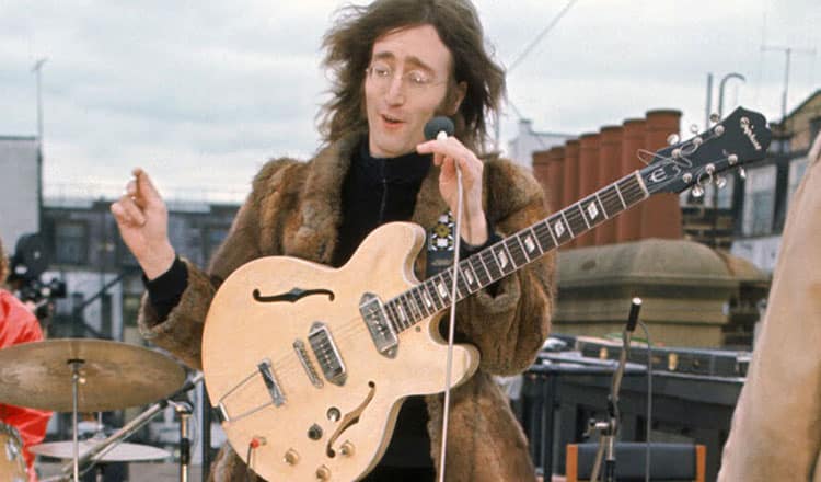 John Lennon in een dakconcert met zijn Epiphone Casino