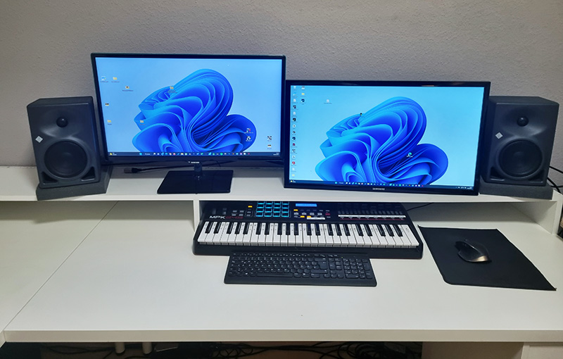 My Akai MIDI keyboard is perfectly placed under the monitors.